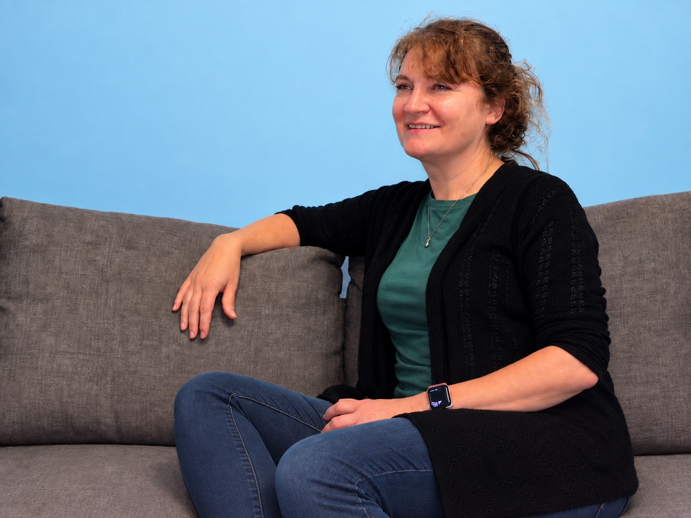 Beth Stoner seated comfortably on a couch